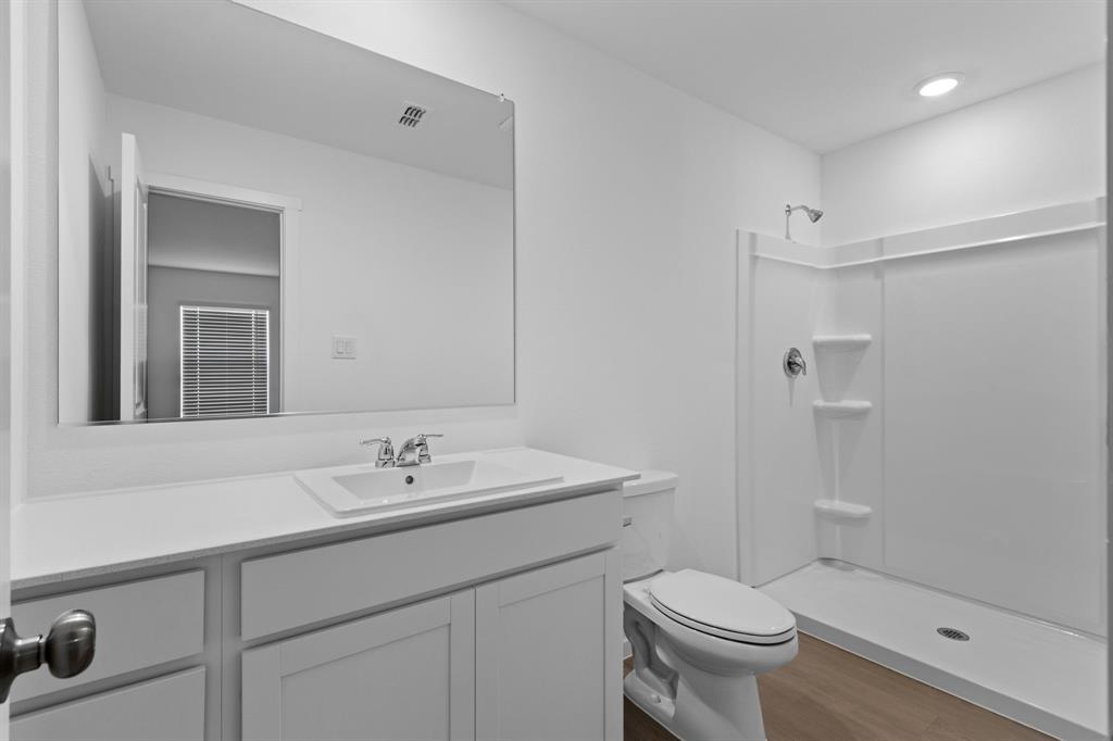 11333 Rodeo Drive Providence Village, TX 76227 - Photo 18 of 39 a bathroom with a sink toilet and shower