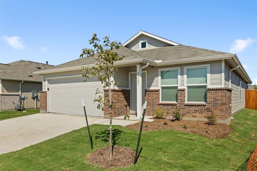 11333 Rodeo Drive Providence Village, TX 76227 - Photo 2 of 39 a front view of a house with garden