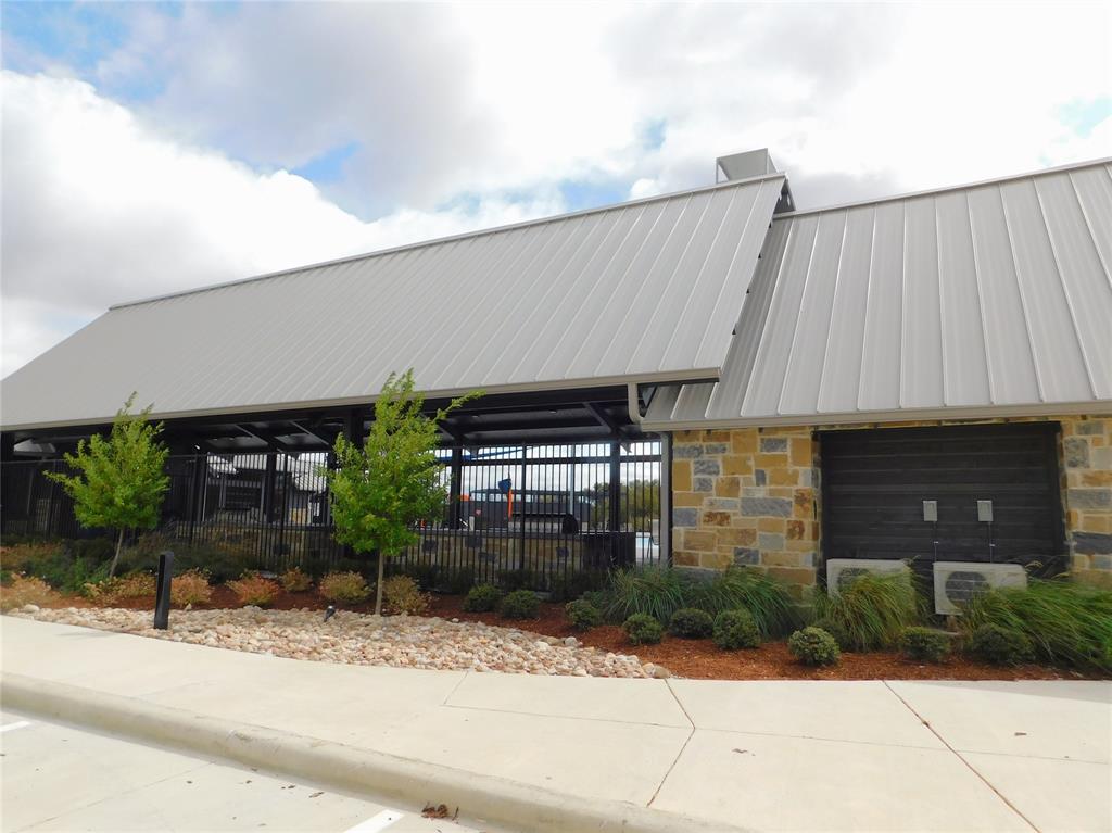 11333 Rodeo Drive Providence Village, TX 76227 - Photo 33 of 39 a front view of a building with garden
