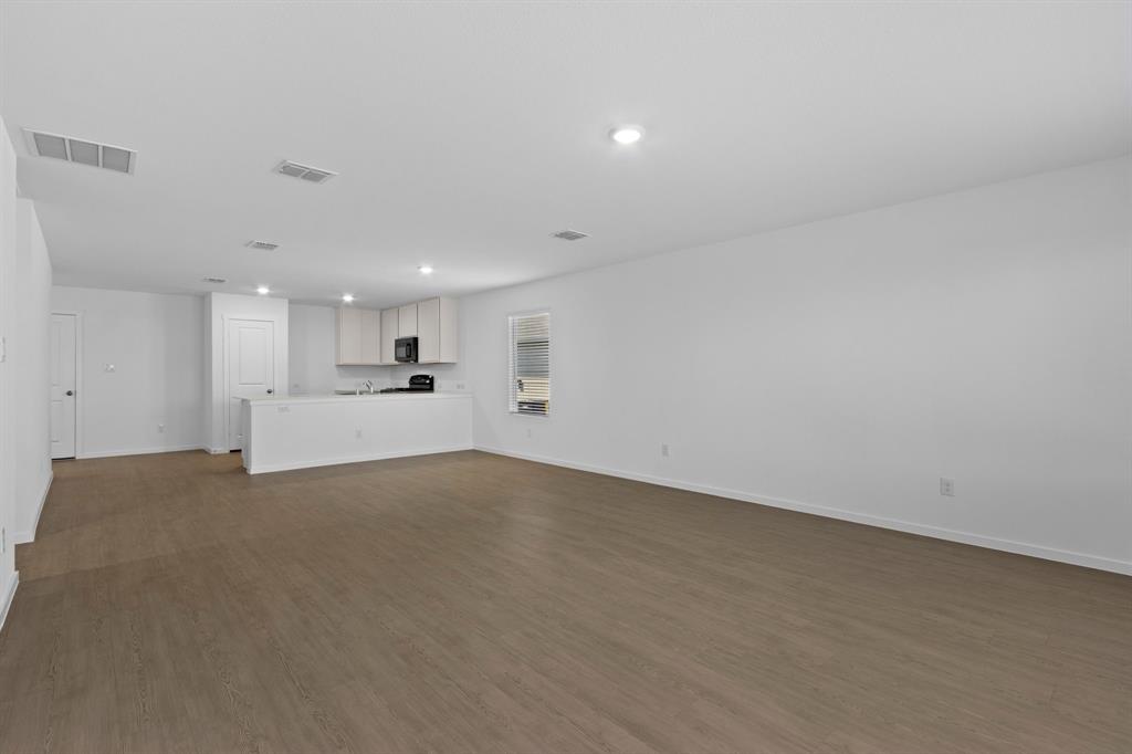 11333 Rodeo Drive Providence Village, TX 76227 - Photo 10 of 39 a view of a livingroom with kitchen appliances and cabinets