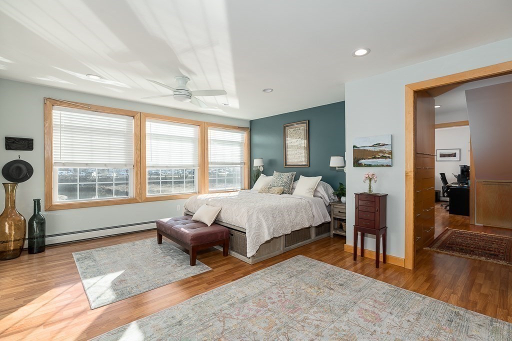 8 Rio Drive Gloucester, MA 01930 - Photo 17 of 33 a spacious bedroom with a bed a table and chair