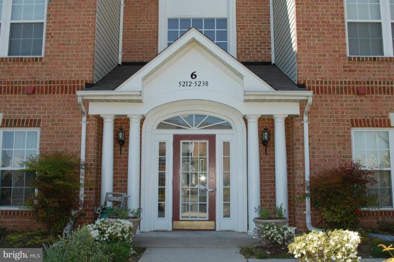 5238 Glenthorne Court, Unit 5238 Rosedale, MD 21237 - Photo 2 of 14 a view of a brick house with large windows and plants