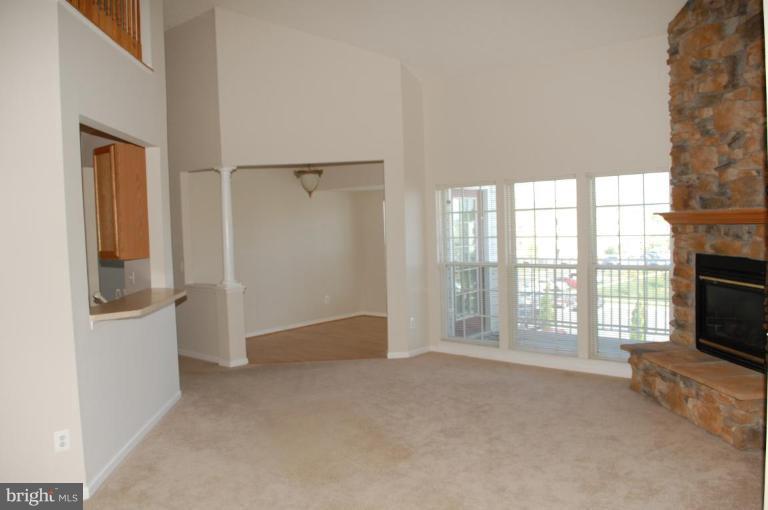 5238 Glenthorne Court, Unit 5238 Rosedale, MD 21237 - Photo 11 of 14 a view of an empty room with a fireplace and a window