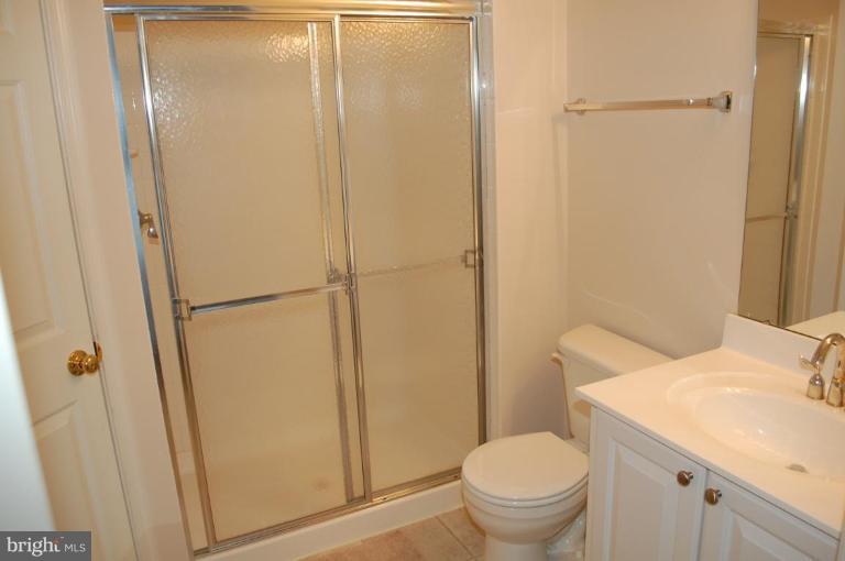 5238 Glenthorne Court, Unit 5238 Rosedale, MD 21237 - Photo 3 of 14 a white toilet sitting next to a bathroom sink