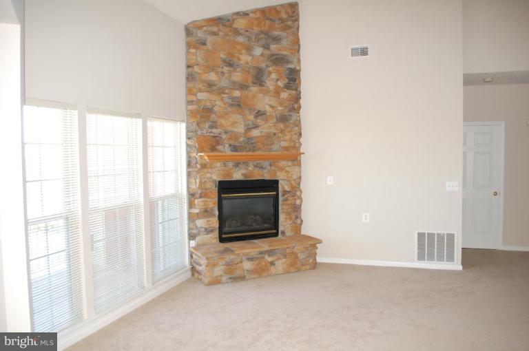 5238 Glenthorne Court, Unit 5238 Rosedale, MD 21237 - Photo 8 of 14 a living room with a fireplace in it