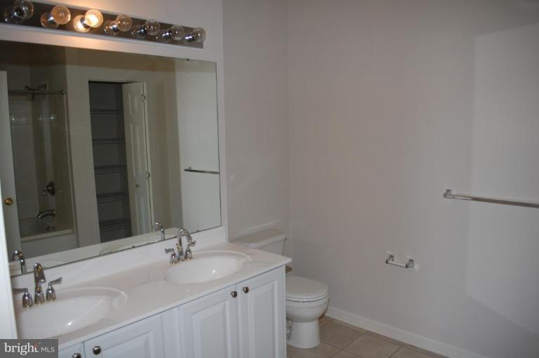 5238 Glenthorne Court, Unit 5238 Rosedale, MD 21237 - Photo 9 of 14 a bathroom with a sink toilet and mirror