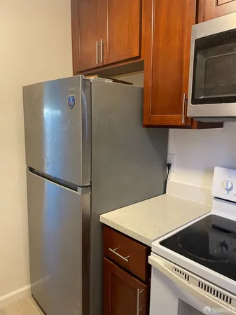 a kitchen with a refrigerator and cabinets