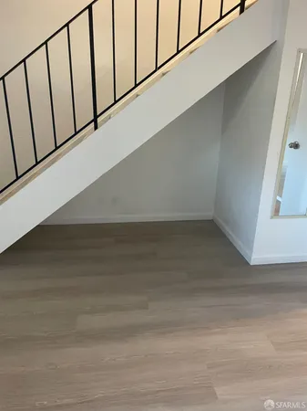 a view of staircase with white walls and railing