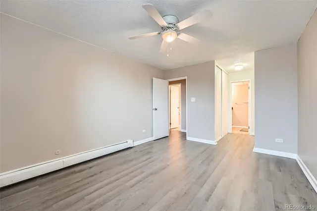 a view of an empty room with wooden floor