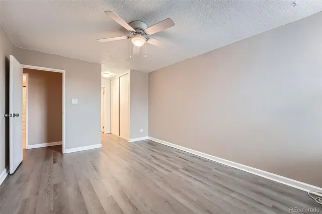 a view of an empty room with wooden floor