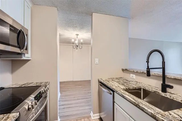 a kitchen with a sink and a stove top oven