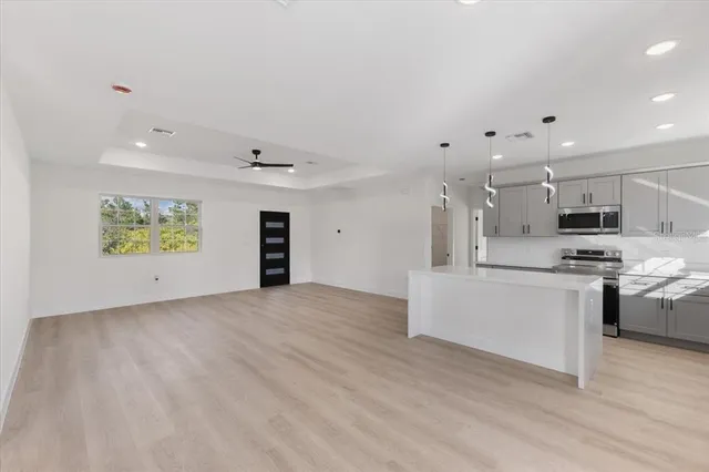 a view of a room with wooden floor and window