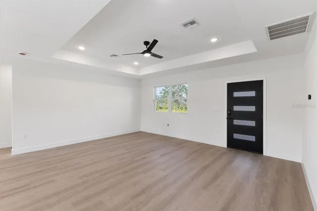 wooden floor in an empty room with a window