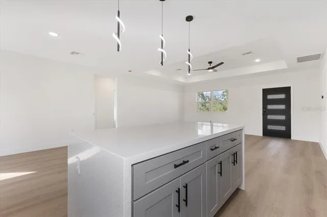 a kitchen with stainless steel appliances granite countertop a sink a stove and a microwave