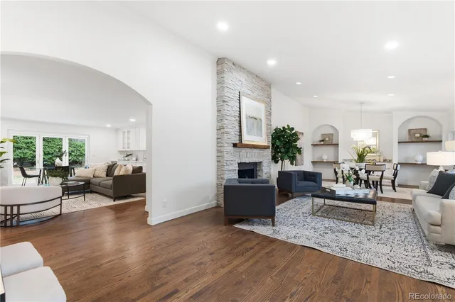 a living room with furniture fireplace and a table