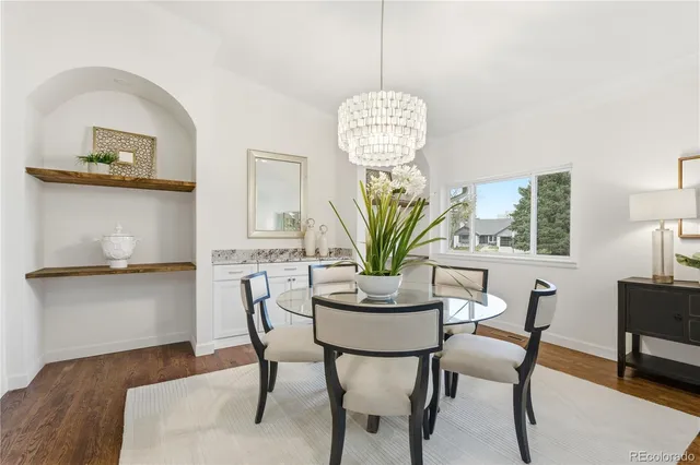 a living room with furniture kitchen view and a table
