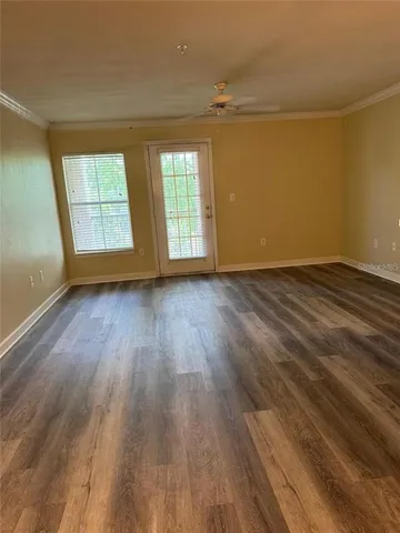 wooden floor in an empty room with a window