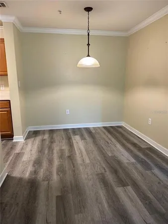 a view of a room with wooden floor and chandelier