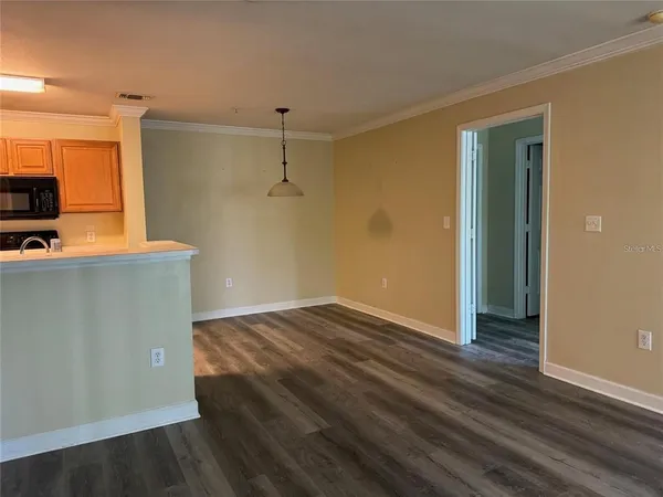 a view of empty room with wooden floor