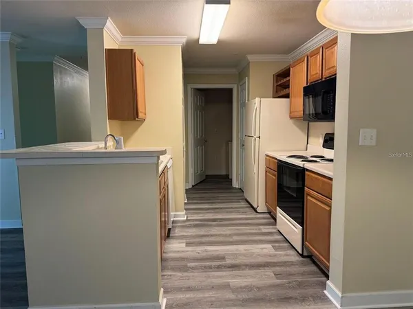 a kitchen with stainless steel appliances a refrigerator and a stove