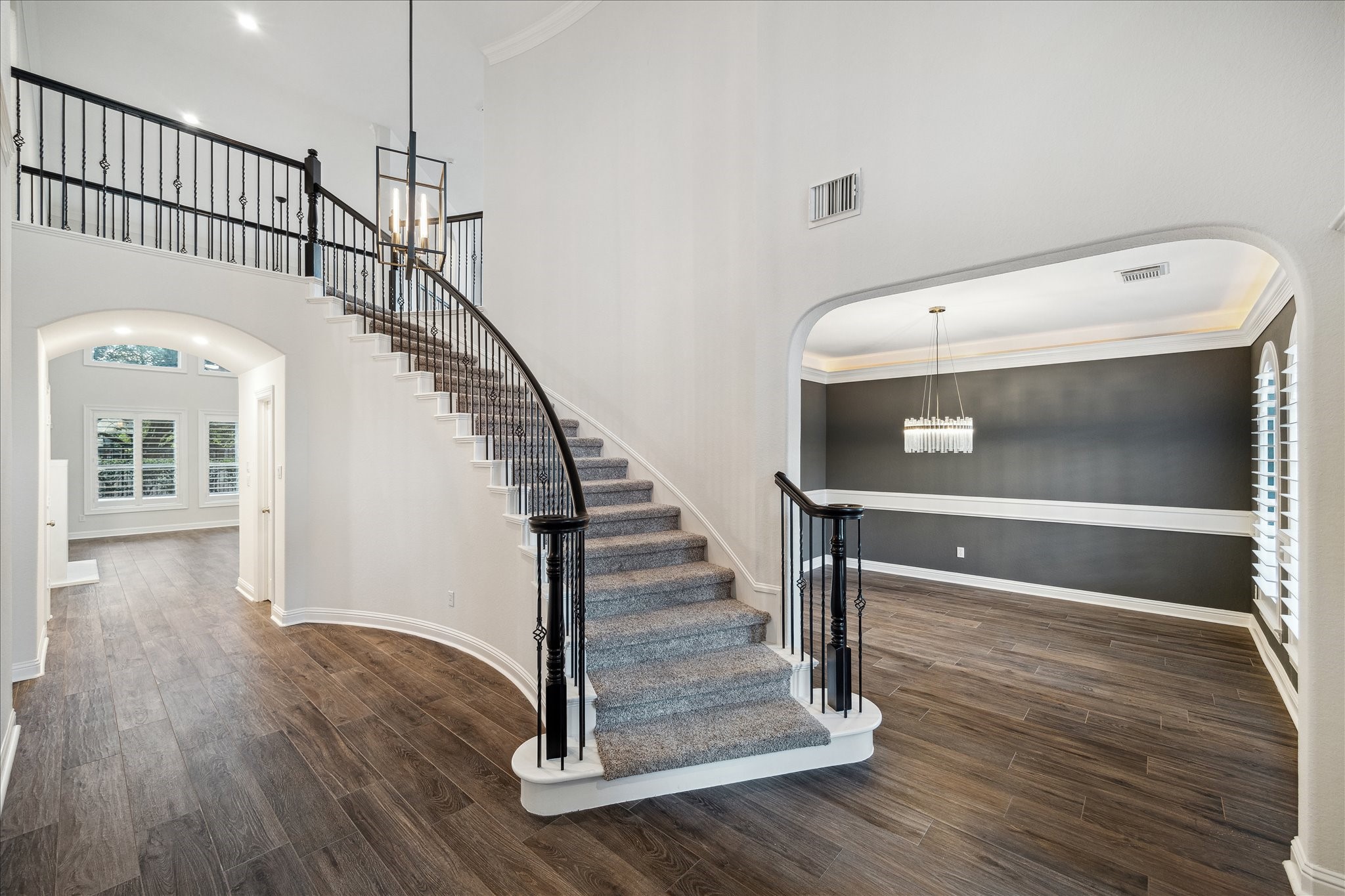 6211 Alameda Point Lane Houston, TX 77041 - Photo 5 of 50 Soaring entryway with sweeping curved staircase and wood-like tile flooring sets the tone.