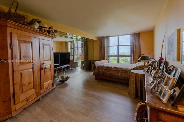 a bathroom with a granite countertop sink a toilet a mirror and bathtub