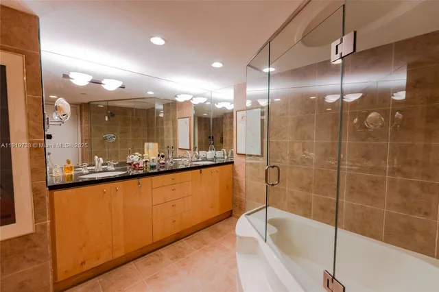 a view of a white building with a garden and pathway