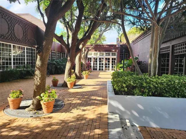 a living room with furniture a flat screen tv and a table