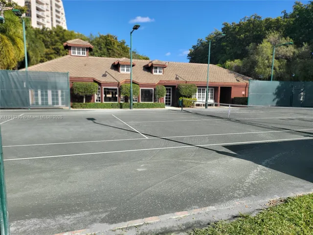 a view of a patio with couches table and chairs potted plants and large tree