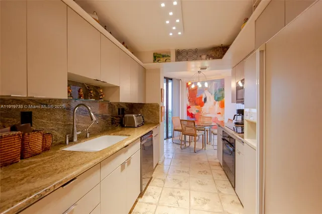 a dining room with furniture and chandelier kitchen view