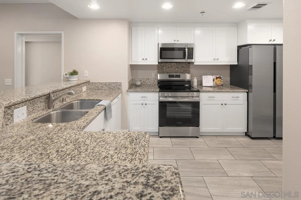 9229 Regents Road, Unit L124 La Jolla, CA 92037 - Photo 1 of 46 a kitchen with a sink cabinets and stainless steel appliances