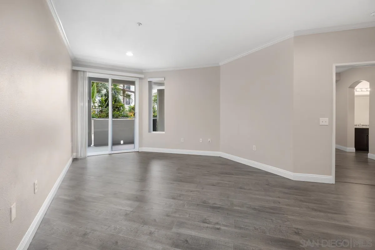 9229 Regents Road, Unit L124 La Jolla, CA 92037 - Photo 11 of 46 a view of an empty room with wooden floor and a window