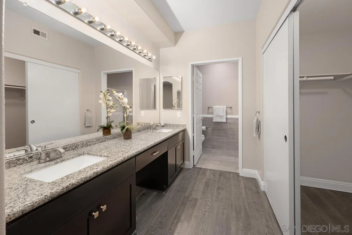 9229 Regents Road, Unit L124 La Jolla, CA 92037 - Photo 16 of 46 a bathroom with a granite countertop double vanity and a sink