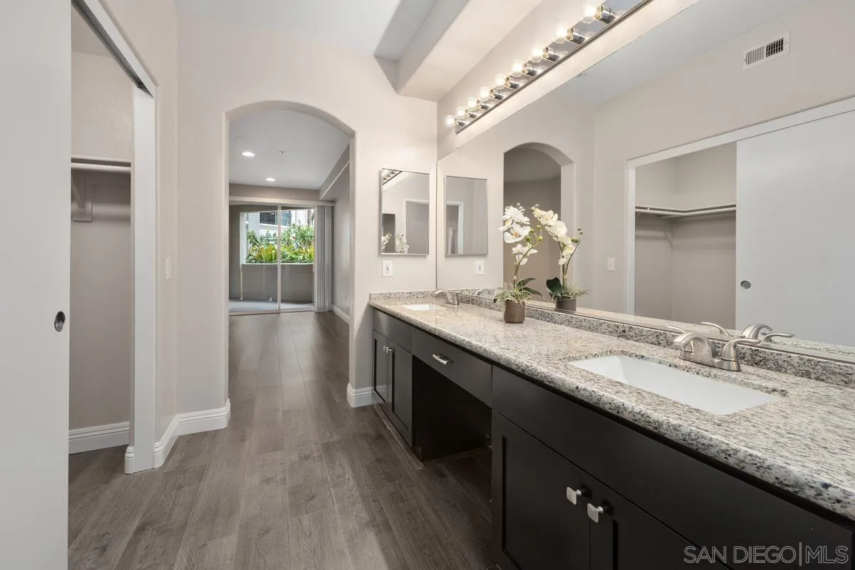 9229 Regents Road, Unit L124 La Jolla, CA 92037 - Photo 19 of 46 a bathroom with a granite countertop double vanity sink and a mirror