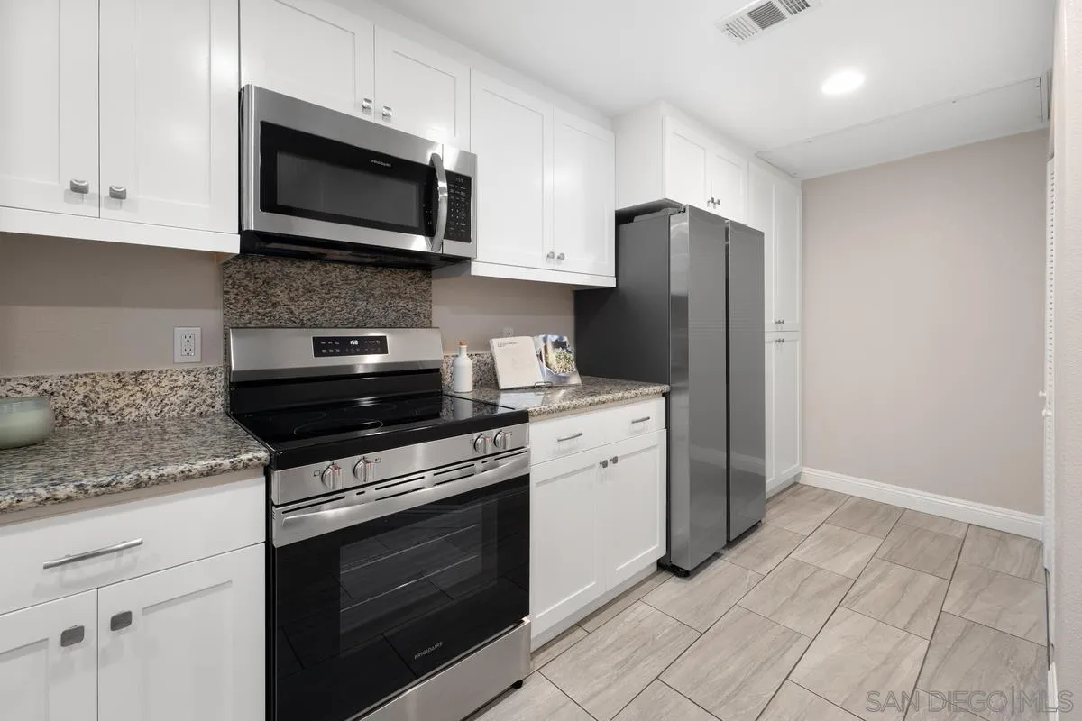 9229 Regents Road, Unit L124 La Jolla, CA 92037 - Photo 2 of 46 a kitchen with stainless steel appliances granite countertop white cabinets sink and stainless steel appliances