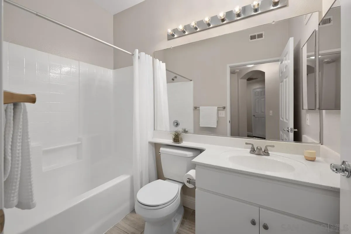 9229 Regents Road, Unit L124 La Jolla, CA 92037 - Photo 26 of 46 a bathroom with a sink toilet a mirror and shower