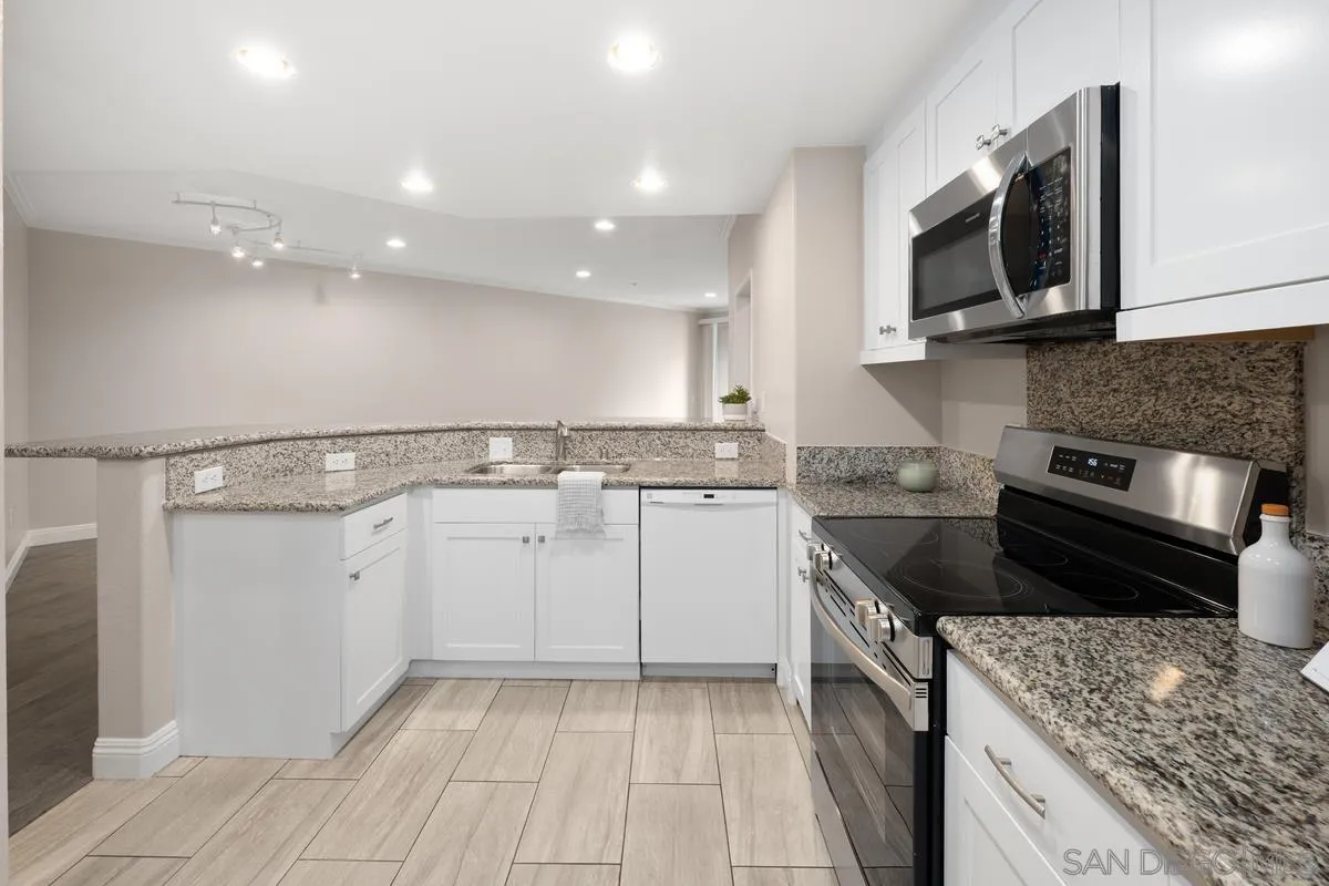 9229 Regents Road, Unit L124 La Jolla, CA 92037 - Photo 3 of 46 a kitchen that has a sink and a stove