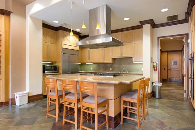 a view of a room with kitchen view and a potted plant