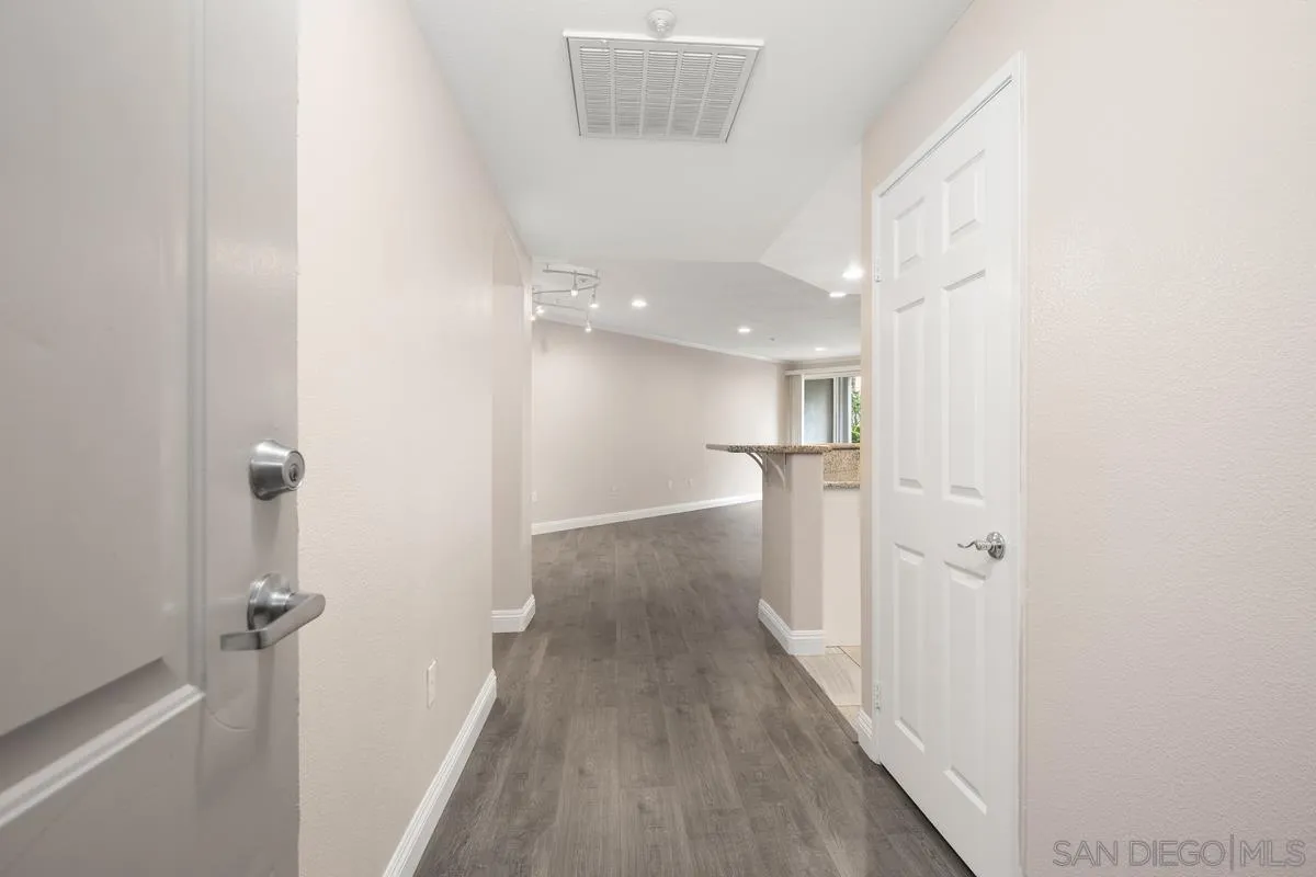9229 Regents Road, Unit L124 La Jolla, CA 92037 - Photo 5 of 46 a view of a hallway with wooden floor and a bathroom