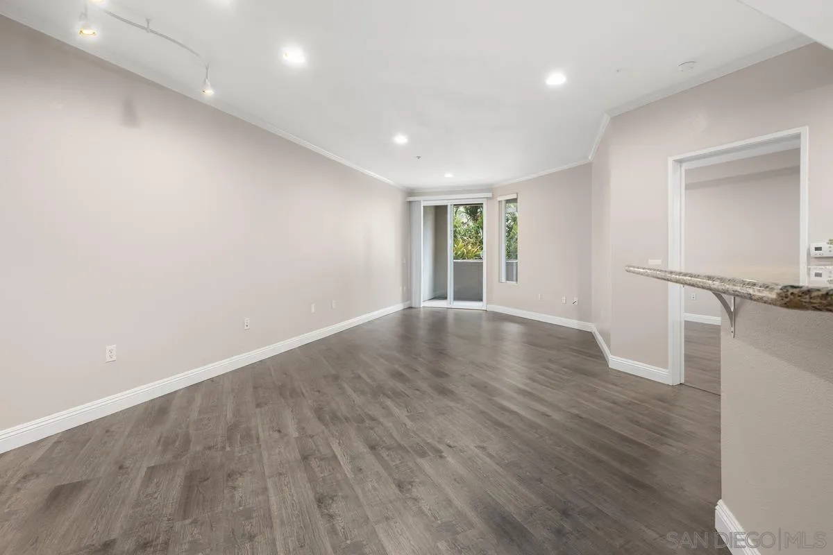 9229 Regents Road, Unit L124 La Jolla, CA 92037 - Photo 9 of 46 an empty room with wooden floor and windows