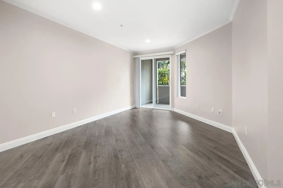 9229 Regents Road, Unit L124 La Jolla, CA 92037 - Photo 10 of 46 an empty room with wooden floor and windows