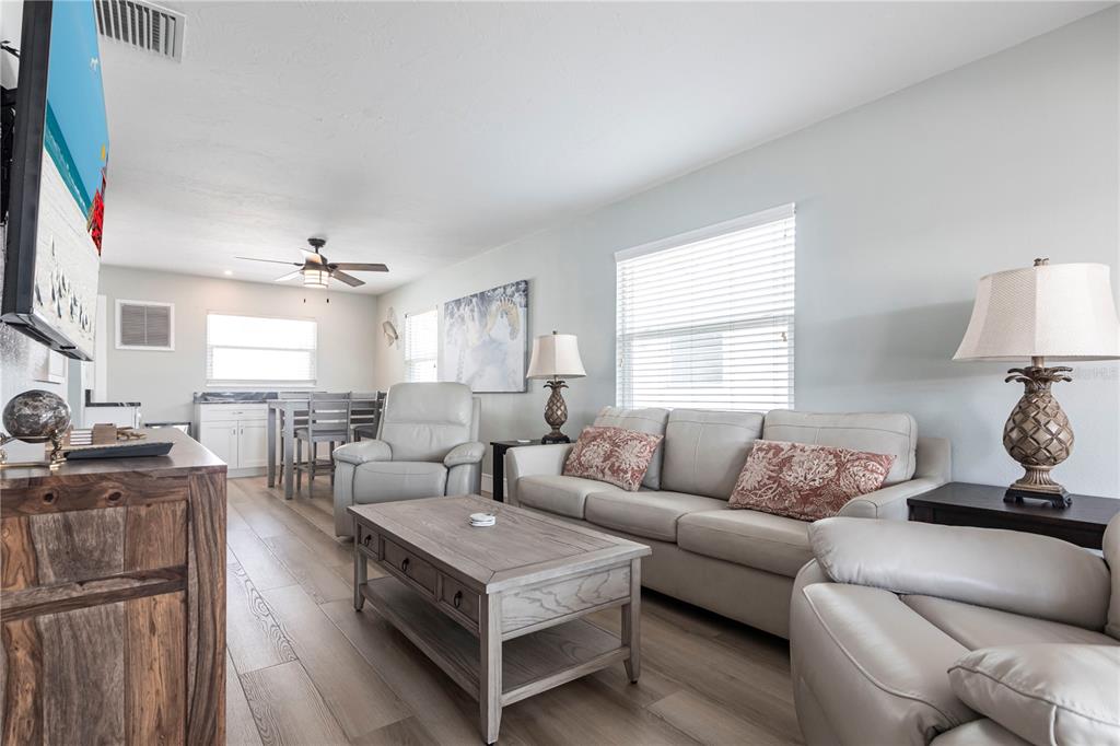 6020 Midnight Pass Road, Unit 35 Sarasota, FL 34242 - Photo 2 of 13 a living room with furniture and a flat screen tv