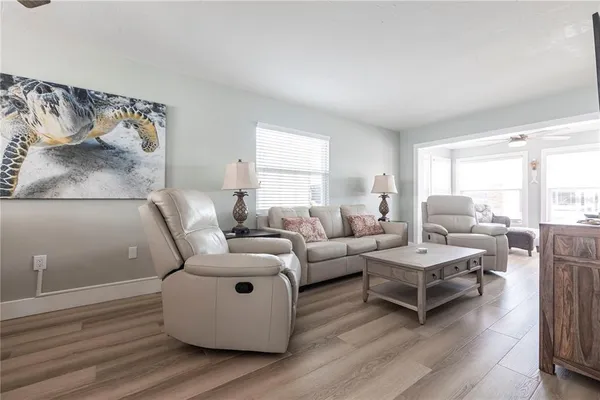 a living room with furniture and wooden floor