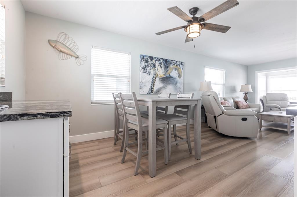 6020 Midnight Pass Road, Unit 35 Sarasota, FL 34242 - Photo 6 of 13 a view of a dining room with furniture window and wooden floor