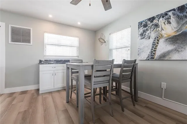 a view of a dining room with furniture and wooden floor