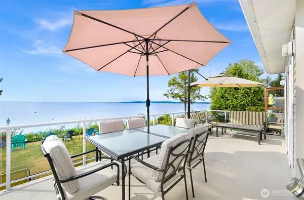 a view of a patio with a table and chairs under an umbrella