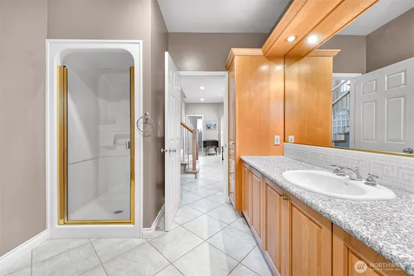a bathroom with a granite countertop sink and a mirror