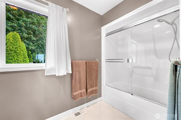a bathroom with a bathtub and a shower