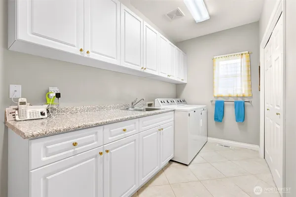 a kitchen with granite countertop white cabinets and white appliances