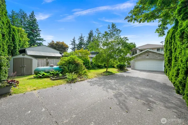 a view of a house with a yard and garage